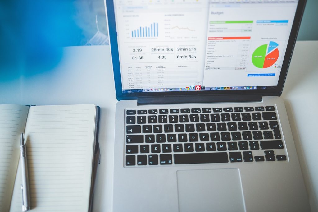 notes and graphs on a laptop on important sales analytics to track