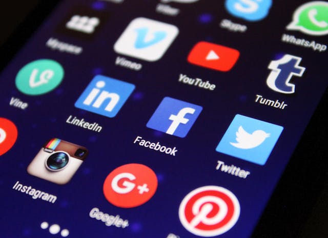 Close-up of various social media apps on the phone.